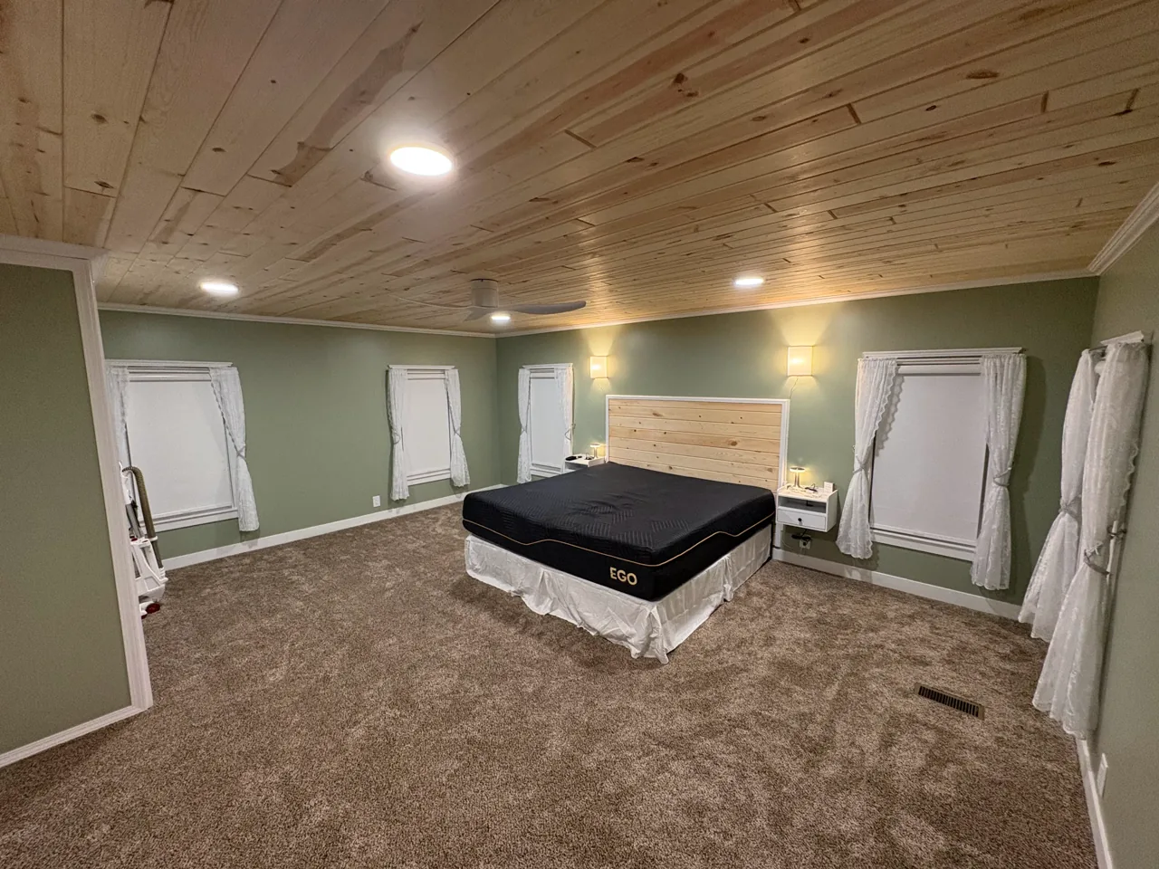 A bedroom with new wall-to-wall carpet installed by Nelson Floor Covering